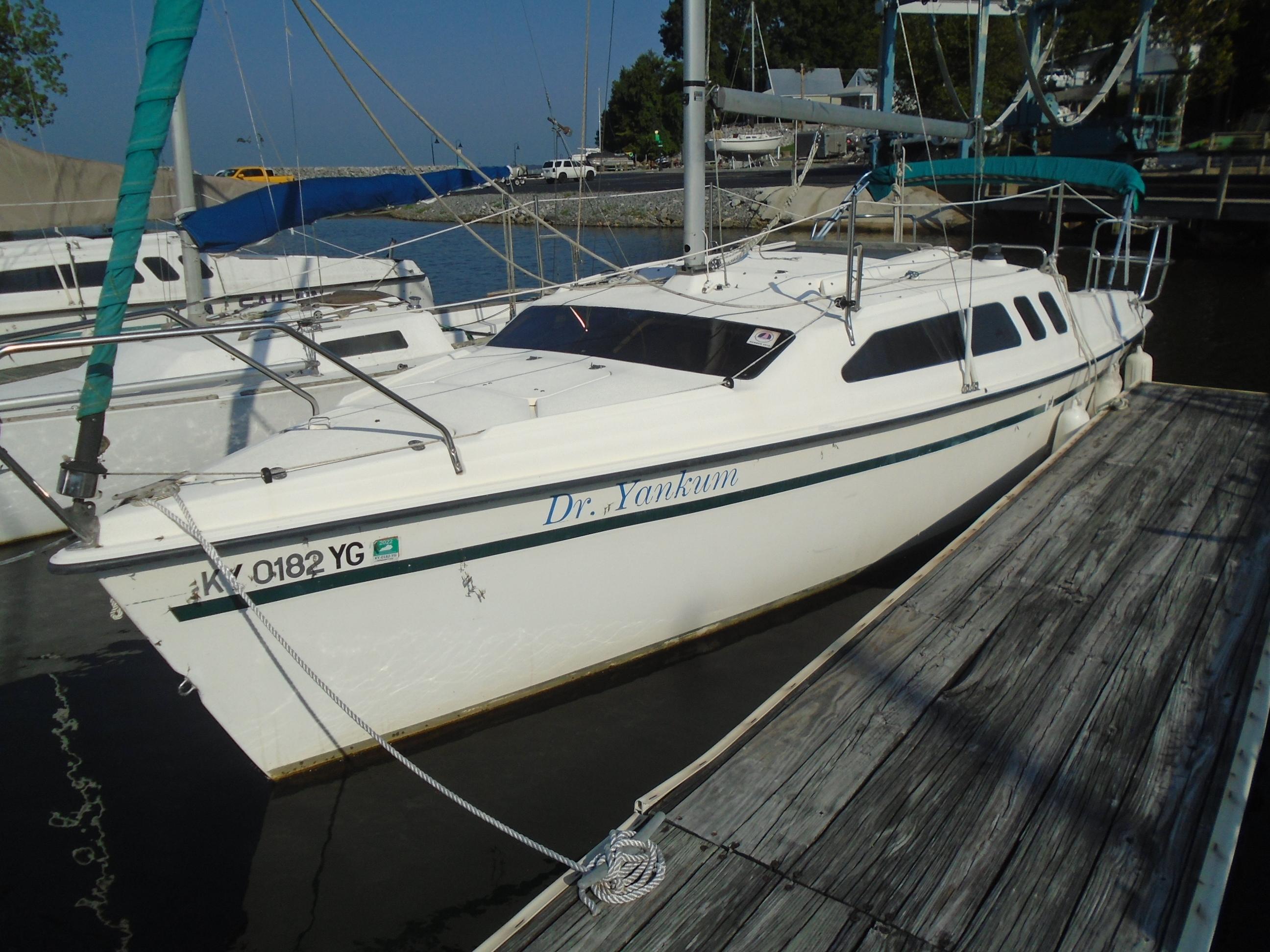 Hunter 23.5 1996 Hunter 23.5 sailboat docked at marina, sunny day.