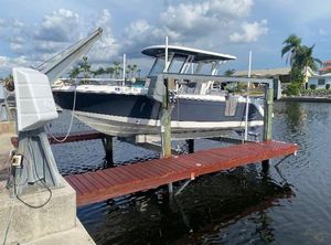 Robalo R272 Center Console 2021 Robalo R272 Center Console boat docked on a lift by the water.