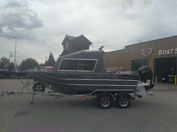 Spartan ASTORIA 185 2025 Spartan ASTORIA 185 boat on a trailer outside a dealership.