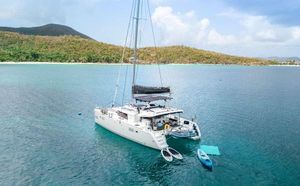 Lagoon 450F 2019 Lagoon 450F catamaran anchored in serene tropical waters with kayaks nearby.