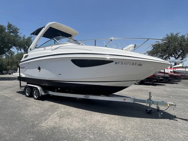 Regal 28 Express 2019 Regal 28 Express boat on a trailer in a parking lot.
