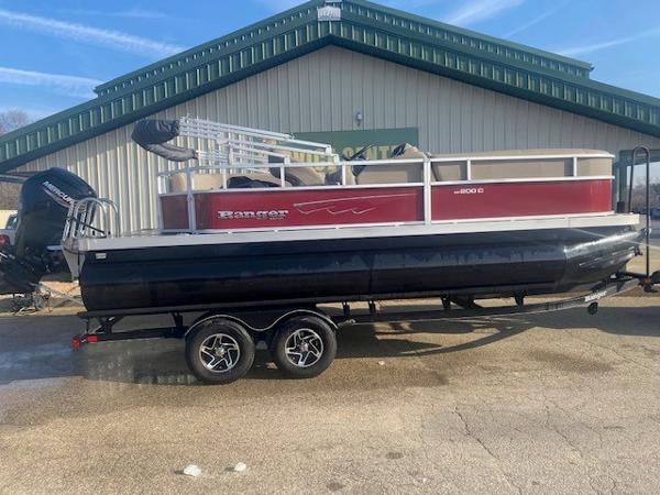 Ranger Reata 200C 2024 Ranger Reata 200C pontoon boat on trailer, parked outdoors.