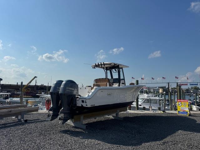 Sea Hunt Gamefish 27 2020 Sea Hunt Gamefish 27 boat with dual engines on display at a marina.