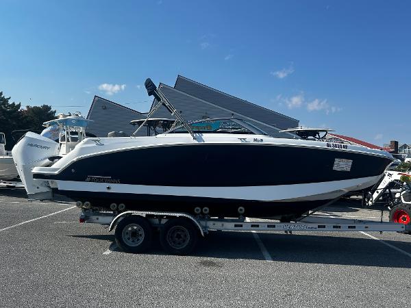 Four Winns HD3 OB 2023 Four Winns HD3 OB boat on trailer in parking lot.