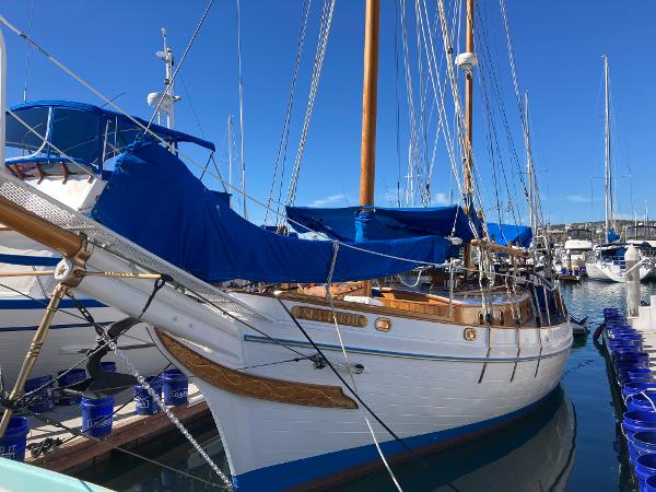 American Marine Seawitch Ketch 1960 American Marine Seawitch Ketch sailboat docked in marina, blue covers, wooden accents.