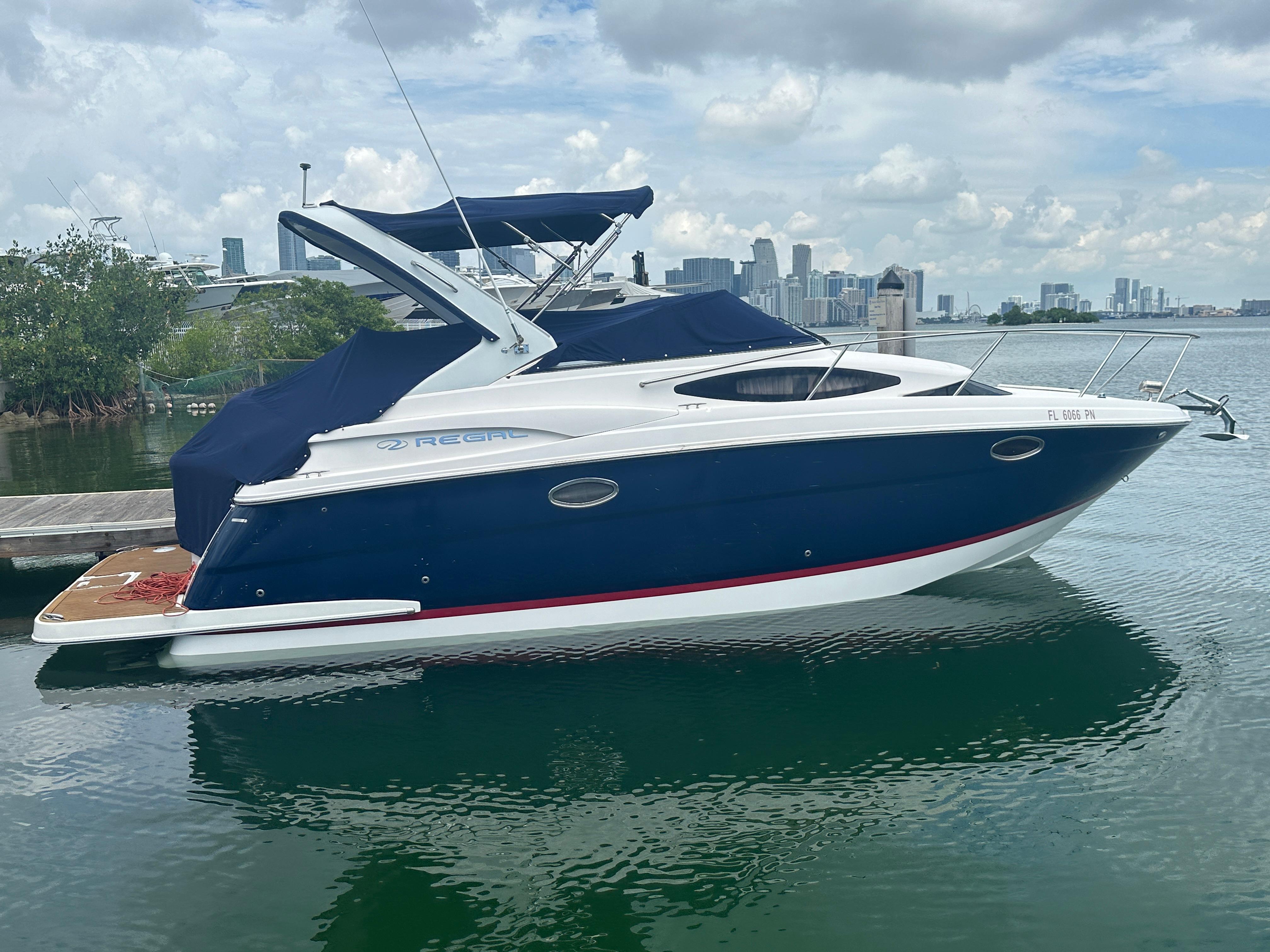 Regal 30 Express 2014 Regal 30 Express boat docked with city skyline in background.