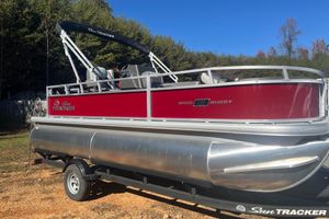 Sun Tracker Bass Buggy 18 DLX 2026 Sun Tracker Bass Buggy 18 DLX pontoon boat with red exterior on a trailer.