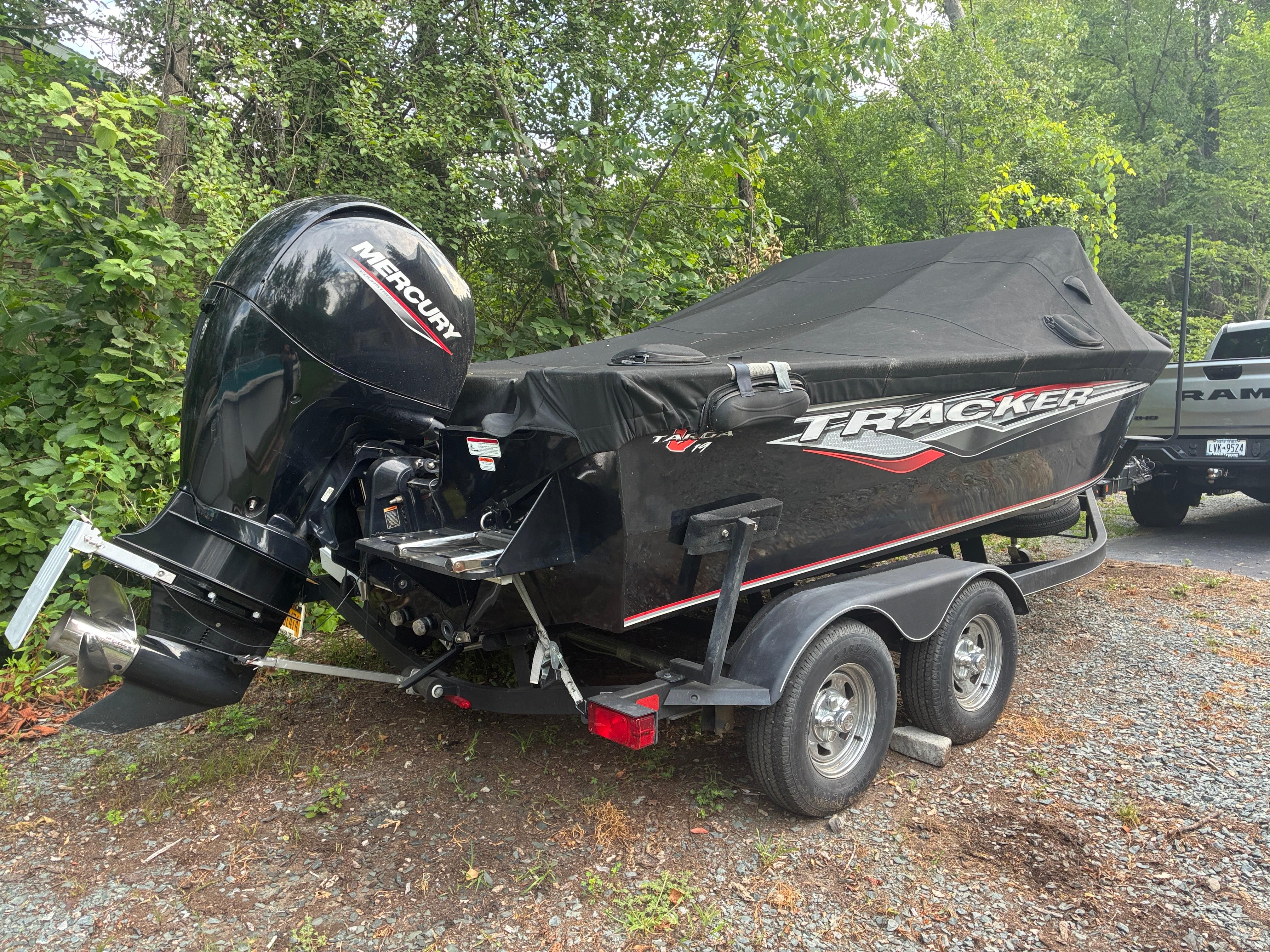 Tracker Targa V-19 Combo 2020 Tracker Targa V-19 Combo boat with Mercury engine on trailer, parked outdoors.