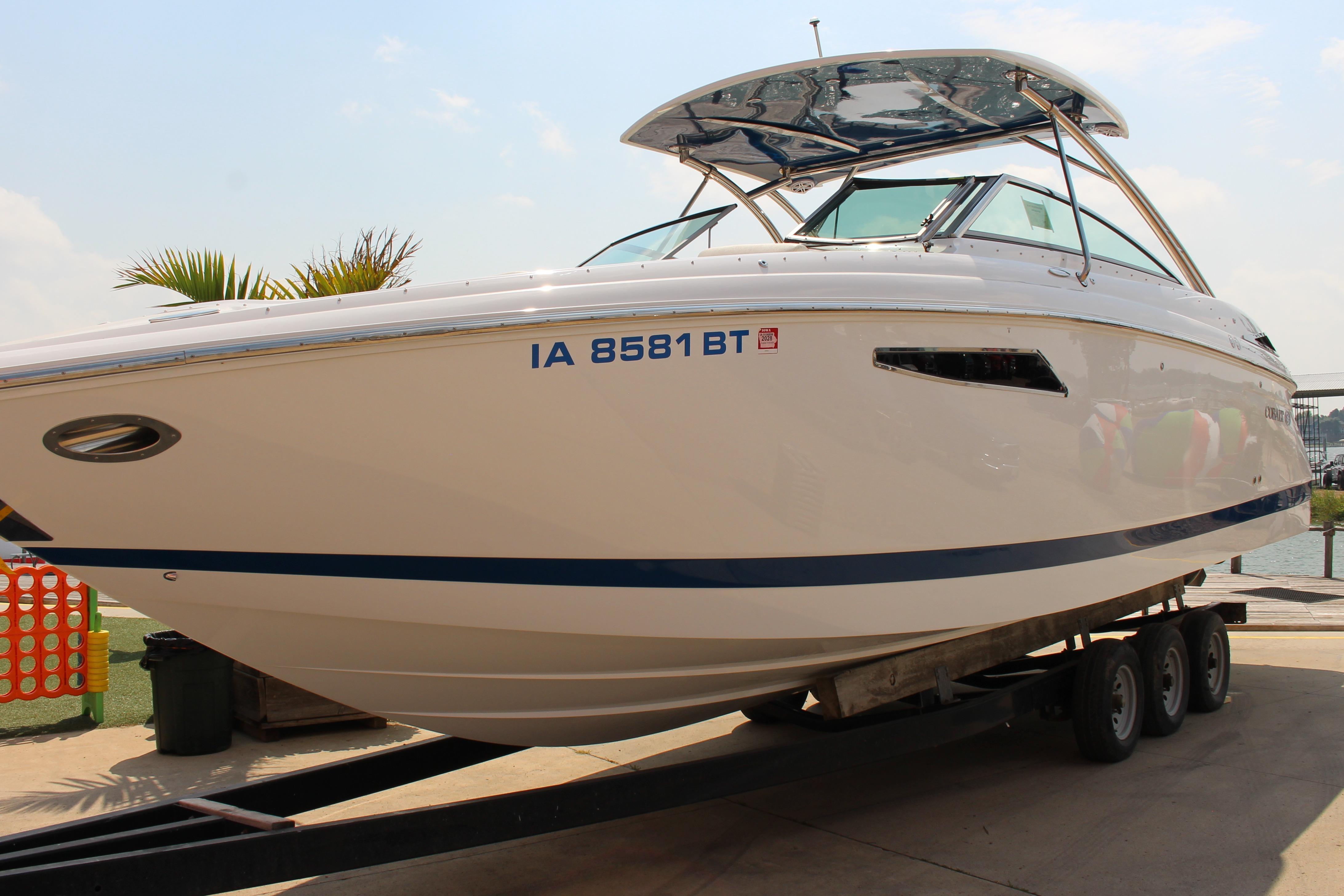 Cobalt R35 2018 Cobalt R35 Surf boat on trailer, sleek design, white and blue accents.
