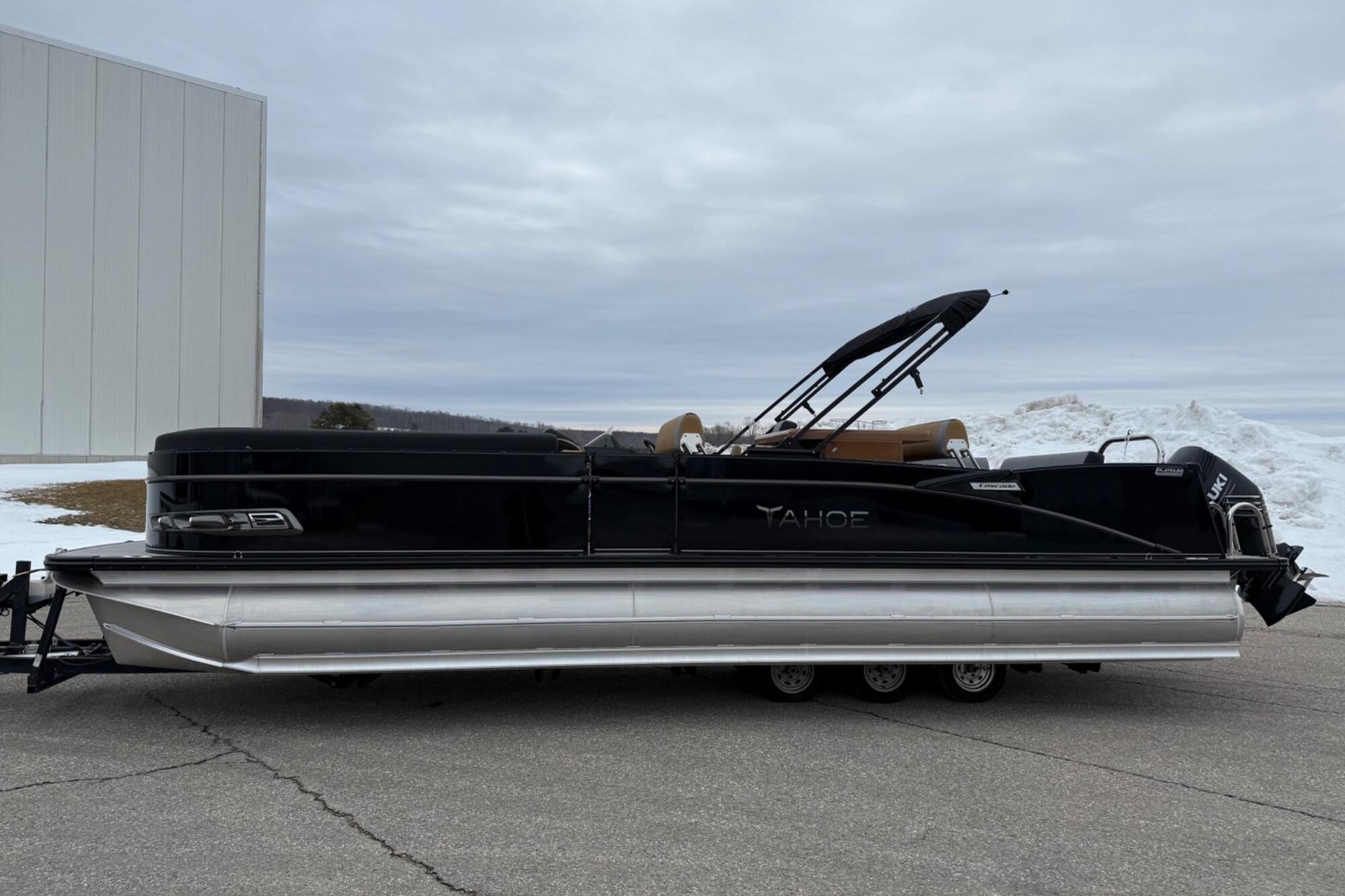 Tahoe 2785 2025 Tahoe 2785 pontoon boat with black exterior, parked on a trailer.