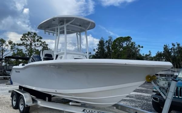 Tidewater 210 LXF 2024 Tidewater 210 LXF boat on trailer, parked outdoors under a cloudy sky.