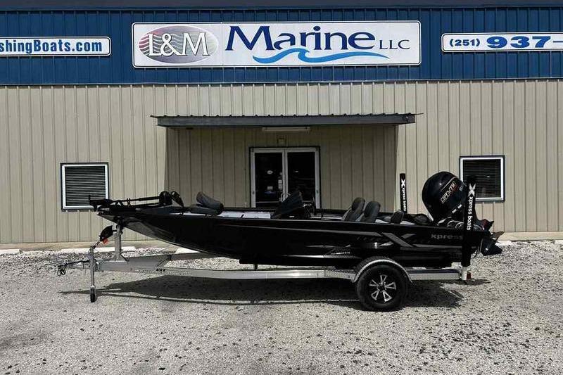 Xpress H18 Bay 2026 Xpress H18 Bay boat on trailer outside L&M Marine dealership.