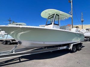 Sea Hunt Ultra 235 SE 2025 Sea Hunt Ultra 235 SE boat on trailer, displayed outdoors under clear blue sky.