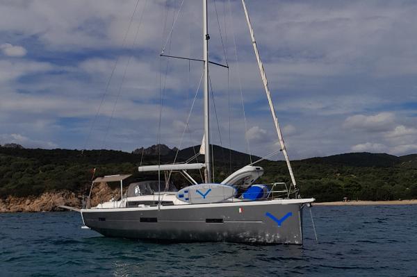 Dufour 460 2019 Dufour 460 sailboat anchored in scenic coastal waters.