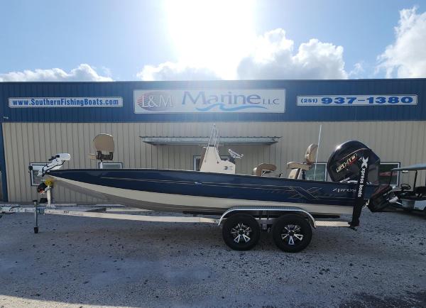 Xpress H22B 2025 Xpress H22B boat on trailer outside L&M Marine dealership.