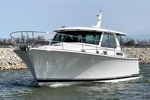 Sabre 45 Salon Express 2025 Sabre 45 Salon Express cruising on water, sleek white design, modern luxury yacht.