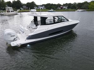Regal 36 XO 2026 Regal 36 XO boat with Yamaha XTO engine on calm water.