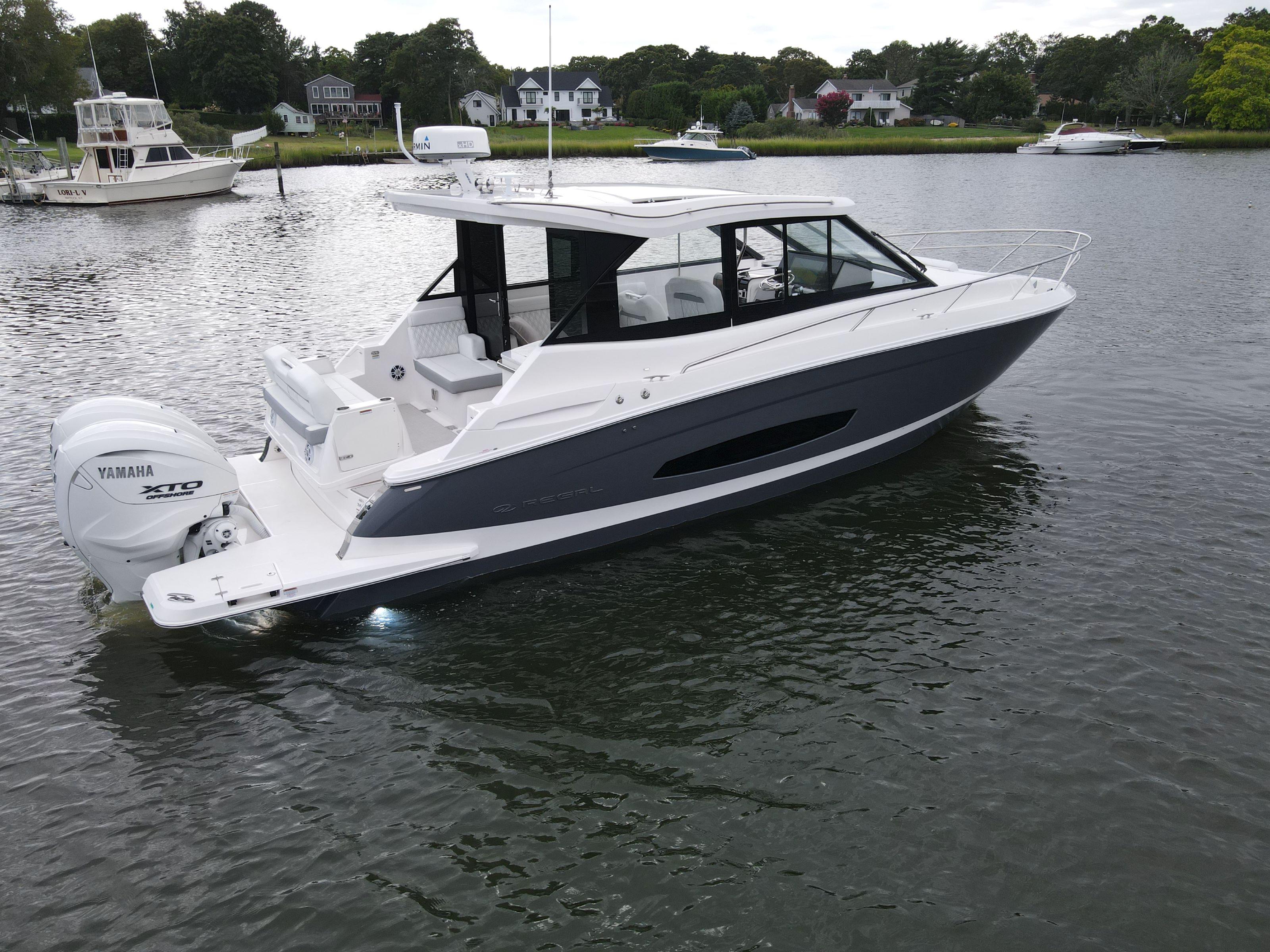 Regal 36 XO 2026 Regal 36 XO boat with Yamaha XTO engine on calm water.