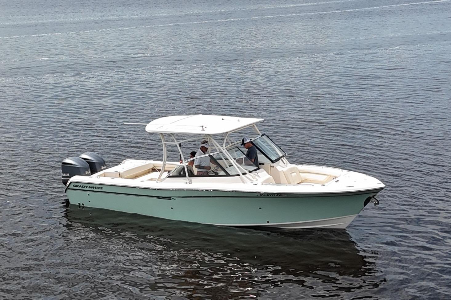 Grady-White Freedom 285 2015 Grady-White Freedom 285 boat on calm water, featuring dual outboard motors.