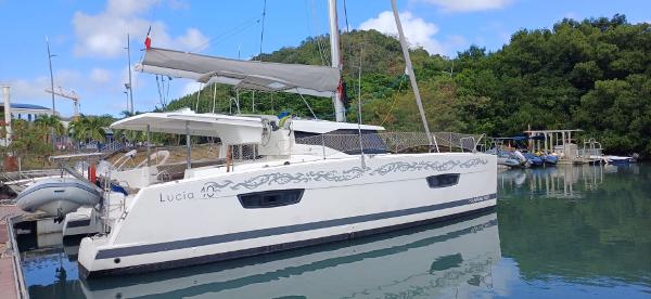 Fountaine Pajot Lucia 40 2017 Fountaine Pajot Lucia 40 catamaran docked in a serene marina setting.