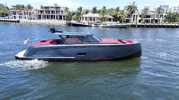 Vanquish Yachts VQ58 2023 Vanquish Yachts VQ58 cruising on a scenic waterfront with luxury homes.