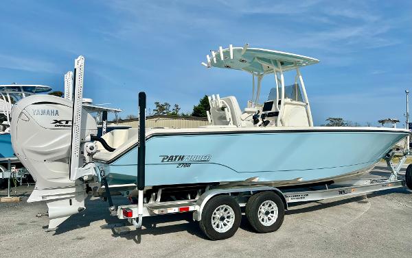 Pathfinder 2700 Open 2024 Pathfinder 2700 Open boat on trailer, featuring Yamaha engine, in a marina setting.