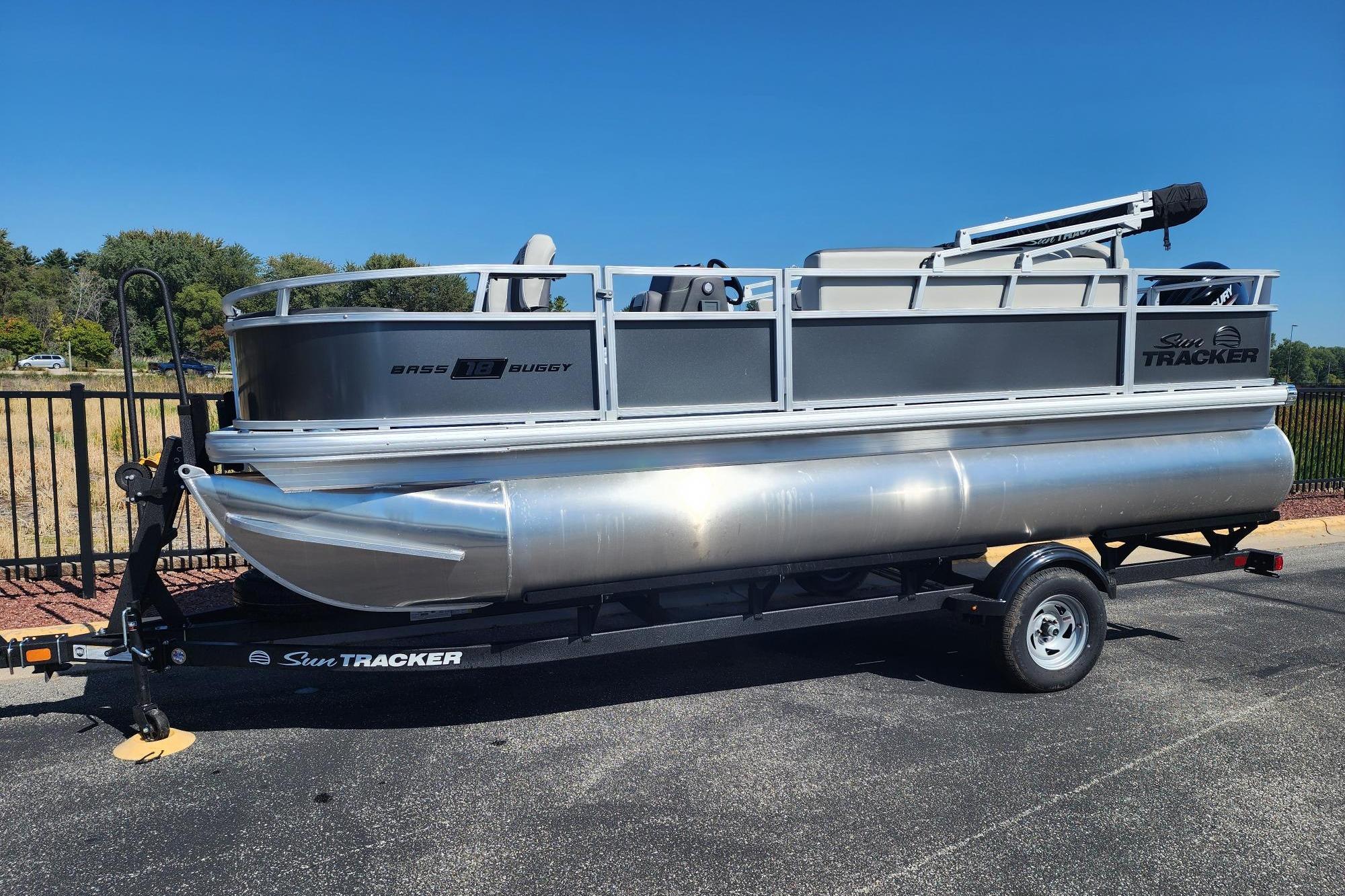 Sun Tracker Bass Buggy 18 DLX 2026 Sun Tracker Bass Buggy 18 DLX pontoon boat on trailer, parked outdoors.