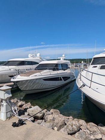 Regal 42 Grande Coupe 2017 Regal 42 Grande Coupe yacht docked at marina under clear blue sky.