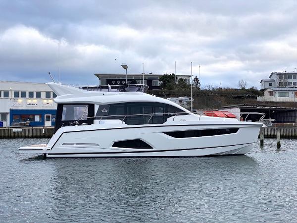 Sealine F430 2025 Sealine F430 yacht docked in a marina, showcasing sleek design and modern architecture.