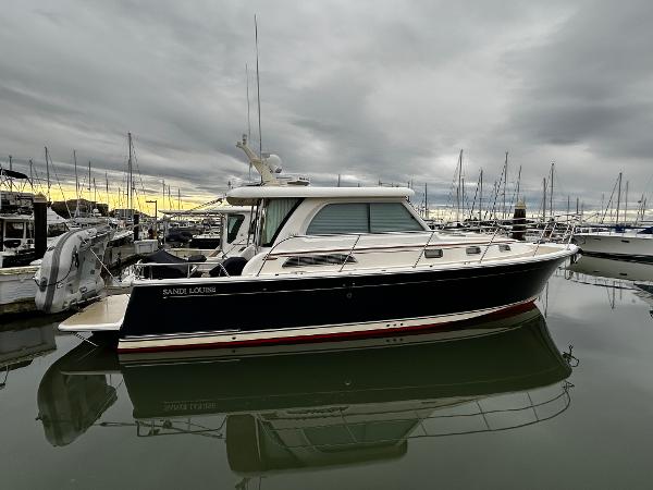 Sabre 38 Salon Express 2013 Sabre 38 Salon Express yacht docked in marina under cloudy sky.