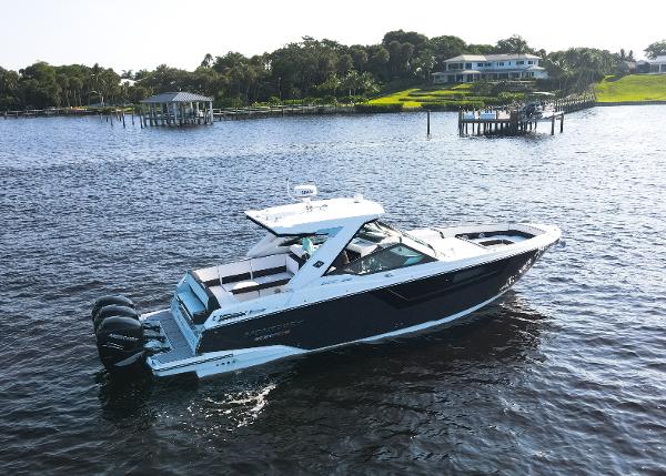Monterey 385 Super Sport 2023 Monterey 385 Super Sport boat cruising on a serene lake with scenic background.