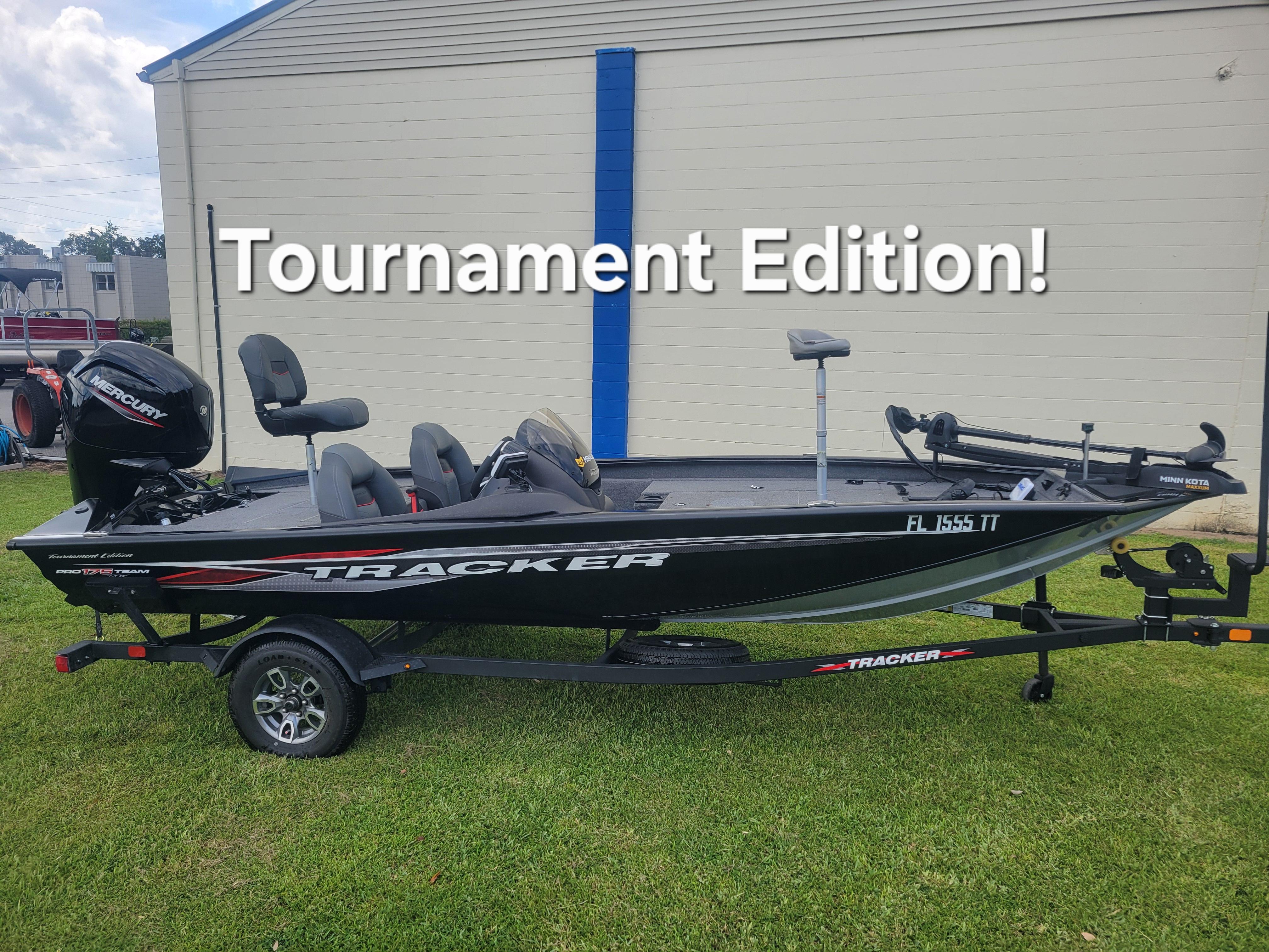 Tracker Pro Team 175 TXW 2024 Tracker Pro Team 175 TXW Tournament Edition boat on trailer, parked on grass.