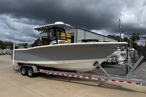 Sea Hunt Gamefish 27 Forward Seating 2021 Sea Hunt Gamefish 27 boat on trailer, parked outdoors under cloudy sky.