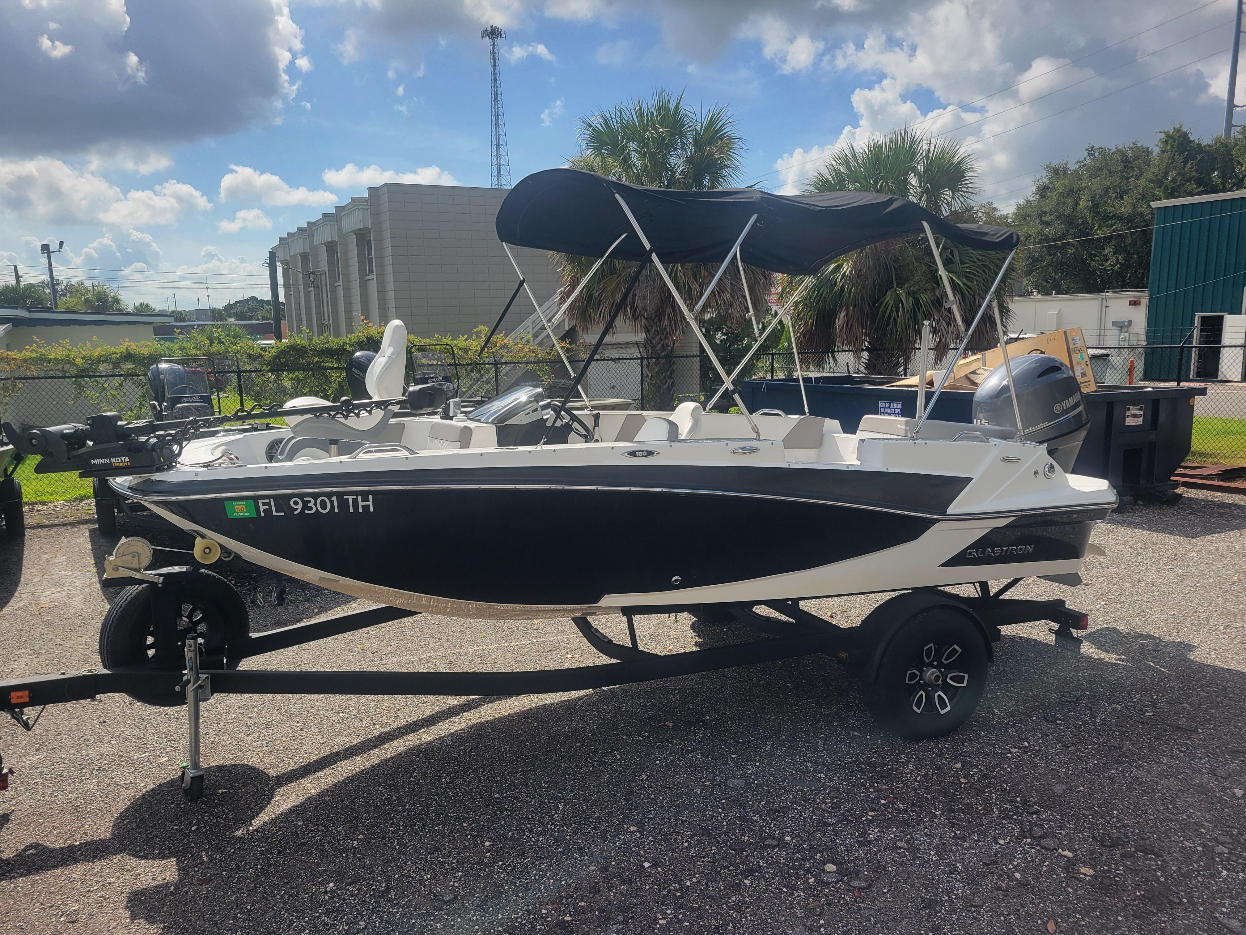 Glastron GTD 180 2022 Glastron GTD 180 boat with canopy on trailer, parked outdoors.