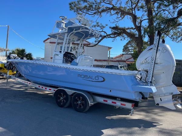 Robalo 266 Cayman SD 2023 Robalo 266 Cayman SD boat on trailer, parked outdoors.