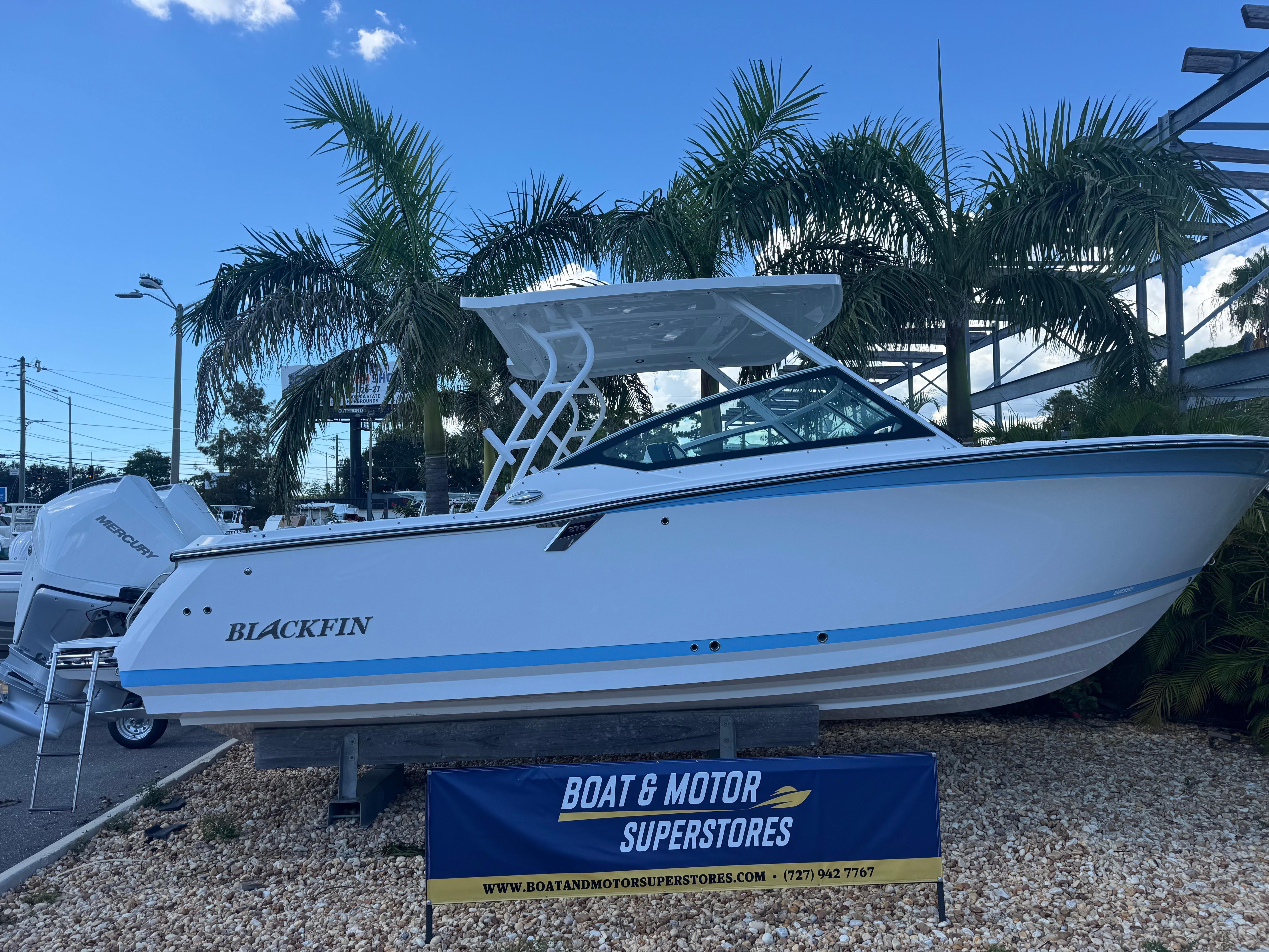 Blackfin 272 DC 2026 Blackfin 272 DC boat displayed at dealership with palm trees in background.
