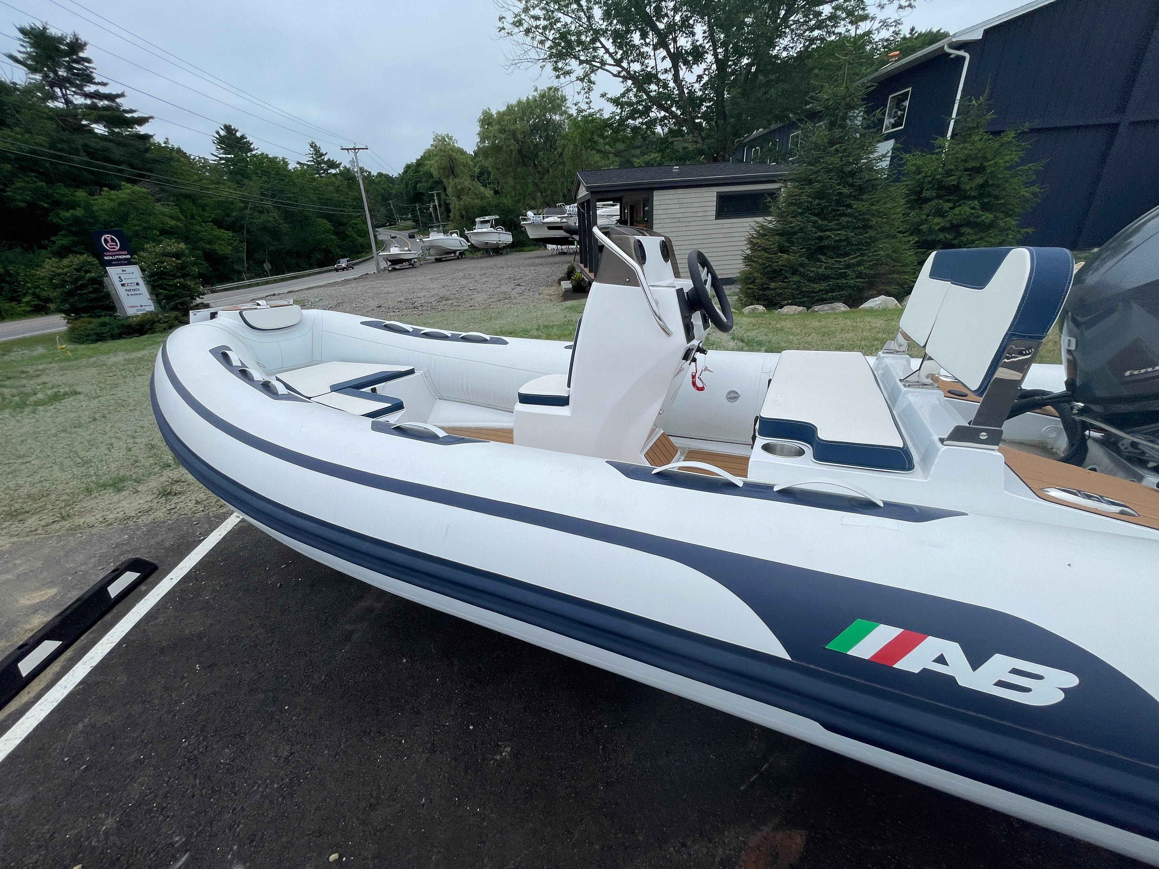 AB Inflatables Alumina 15 ALX 2025 AB Inflatables Alumina 15 ALX boat, white with blue accents, parked outdoors.