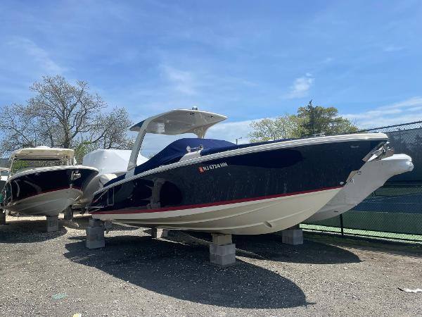 Chris-Craft Launch 28GT 2020 Chris-Craft Launch 28GT boat on display, blue hull, sunny day, outdoor setting.