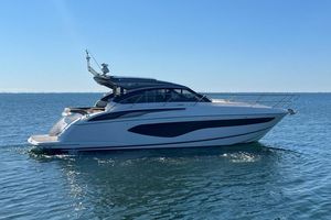 Princess V50 2022 Princess V50 yacht cruising on calm blue waters under clear sky.