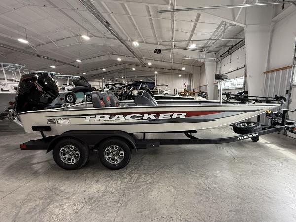 Tracker Savage 215 2025 Tracker Savage 215 boat in showroom, side view, on trailer.