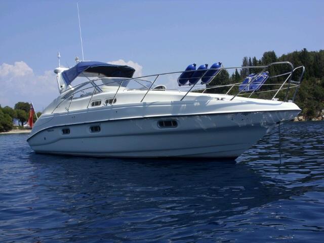 Sealine S34 1998 Sealine S34 yacht on calm water, featuring sleek design and blue canopy.