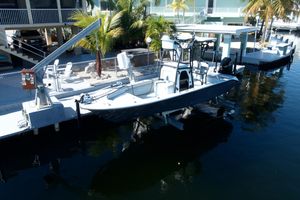 Xplor 24 Andros 2021 Xplor 24 Andros boat docked at a waterfront property with palm trees.