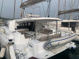 Bali 4.5 2020 Bali 4.5 catamaran with dinghy, docked at marina, featuring spacious deck and seating area.