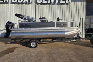 Sun Tracker Bass Buggy 16 XL Select 2026 Sun Tracker Bass Buggy 16 XL Select pontoon boat on trailer outside dealership.