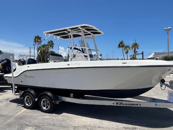 Bayliner Trophy T22CC 2022 Bayliner Trophy T22CC boat on EZ Loader trailer, parked outdoors.