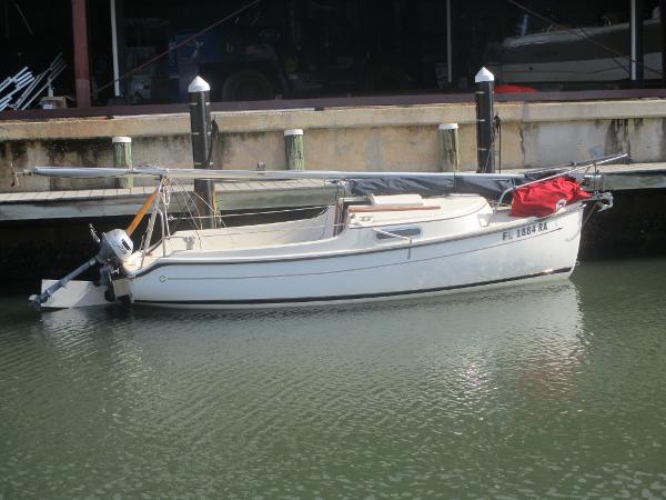 Com-Pac Legacy 17 2016 Com-Pac Legacy 17 sailboat docked in calm waters.