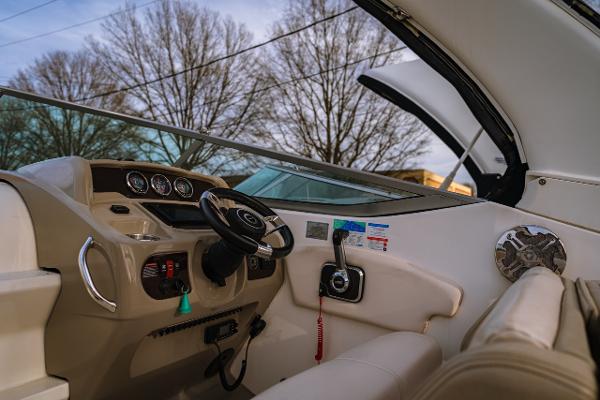 Chaparral 270 Signature Interior view of 2018 Chaparral 270 Signature boat cockpit with steering wheel and controls.
