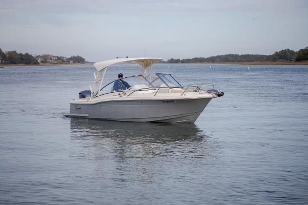 Scout 245 Dorado 2017 Scout 245 Dorado boat cruising on a calm lake.