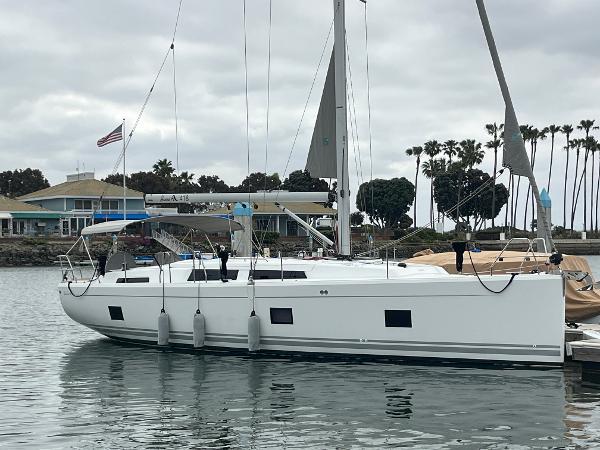 Hanse 418 2021 Hanse 418 sailboat docked in a marina with overcast skies.