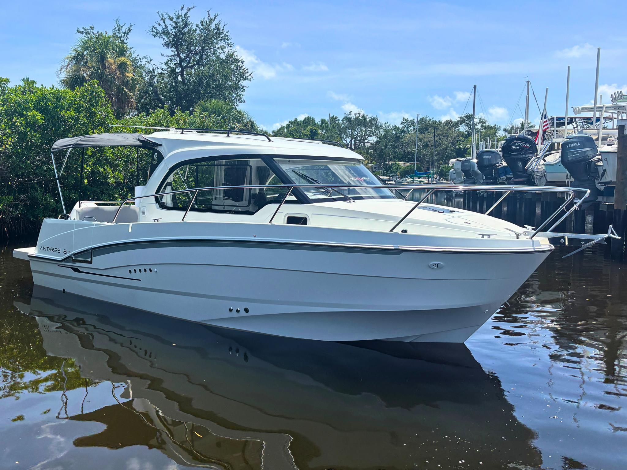 Beneteau Antares 8 2025 Beneteau Antares 8 boat docked on calm water, surrounded by lush greenery.